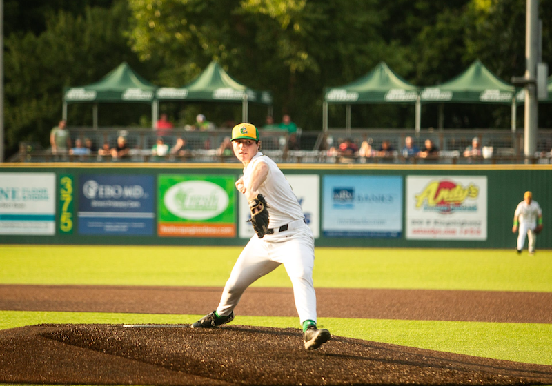 Catfish pitcher in front of the wall of sponsor logos
